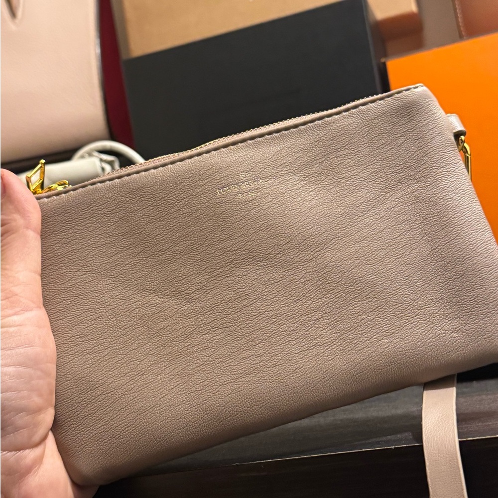 Stylish pouch modeled after an LV pouch and strap.